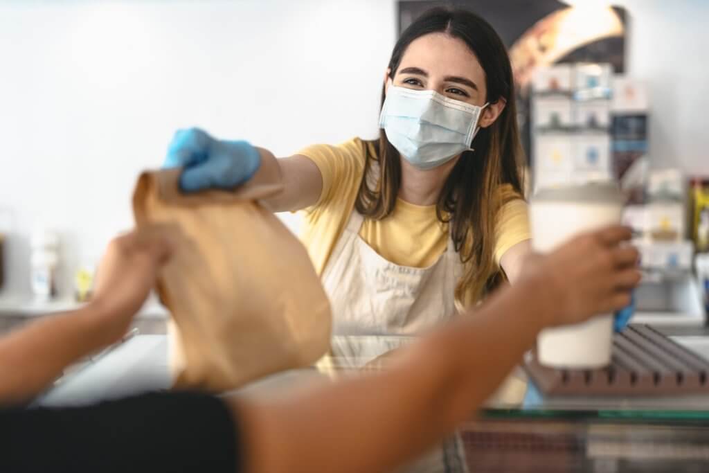 woman working at a coffee shop during covid19